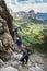 Three mountain climbers on a Via Ferrata in the Dolomites in Alta Badia