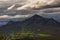 three mountain peaks around the green valley