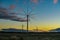 Three moving wind generators before sunrise