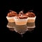 Three muffin cupcake with brown cream and pieces of chocolate