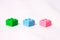 Three multi-colored cubes of lego block green blue pink