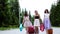 Three multi ethnic girls with suitcases and shopping bags walk on vacation.