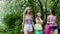 Three multi ethnic happy girls walking with purchases packages after shopping.