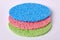Three multicolored household cellulose sponges on a white background