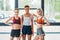 three multicultural female athletes standing and looking at camera