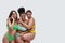 Three multiethnic young women in colorful underwear looking happy, having fun while posing together  over white
