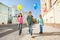 Three multinational kids with colorful balloons