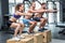 Three muscular athletes doing jumping squats