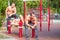 Three muscular men relaxing on a training area background. Training concept. Copy space.