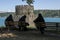 Three Muslim ladies sit infront of Halil Pasha Tower at Rumelhisarii in Istanbul in Turkey.