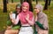 Three Muslim Ladies Video Calling Waving Hello To Smartphone Outdoors