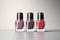 Three nail polish bottles on Gray color background.
