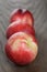 Three nectarines on old wood oak table