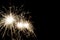 Three New Year sparkler burning isolated on a black background