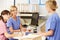 Three Nurses Working At Nurses Station