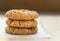 Three oatmeal Anzac biscuits.