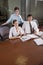 Three office workers working in boardroom