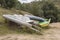 Three old abandoned rusty boats into a andean wild forest