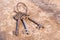 Three old antique metal keys on a rusty metall background. Middle Ages.