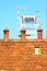 Three old chimney pot with modern construction in the background