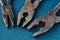 Three old combination used pliers close-up