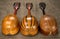 Three old mandolins on a background of rough burlap texture.