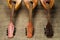 Three old mandolins rotated fingerboards to the camera on a background of rough burlap