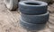 Three old tires stacked, close-up of a truck tire. Environmental pollution. Dump tires