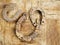 Three old worn horse shoe on a wooden surface, symbol of luck