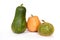 Three orange and green spotted pumpkins stand side by side on a white background