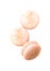 Three orange macaroon cookies isolated