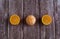 Three orange ripe tandarines on brown wooden background