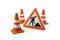 Three orange traffic warning cones or pylons with street or road construction sign on white background - under construction,