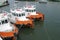 Three orange Tug boats