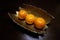 Three oranges on the art brass plate