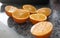 Three oranges cutted in half on a kitchen table