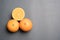 Three oranges on grey background