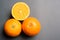 Three oranges on grey background