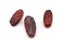 Three organic Medjool dried date fruits isolated on white background