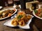 Three oriental dishes with beef, shrimps, tomatoes, carrots, red pepper and rice noodles.