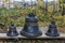 Three Orthodox black bells with gold painting, standing on wooden boards in the autumn day.