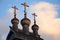 Three Orthodox crosses close-up on wooden domes of an old Russian Church