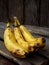 Three overripe bananas on a dark wooden background. selective focus. copy space