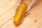 Three overripe yellow cucumbers on the background of old wooden boards. Autumn harvest. Vegetables and dry leaves, stems