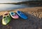 Three paddle boats or paddle skis on the beach