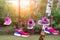 Three pairs of bright sport fitness sneakers hanged on clothespin at backyard after laundry outdoors. Preparartion for