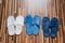 Three pairs of colored Slippers are on the floor in the hotel room