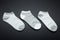 Three pairs of female gray socks on a black background