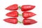 Three pairs of red sweet pepper on white background