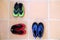 Three pairs of reef shoes, or water shoes, in green, red and blu